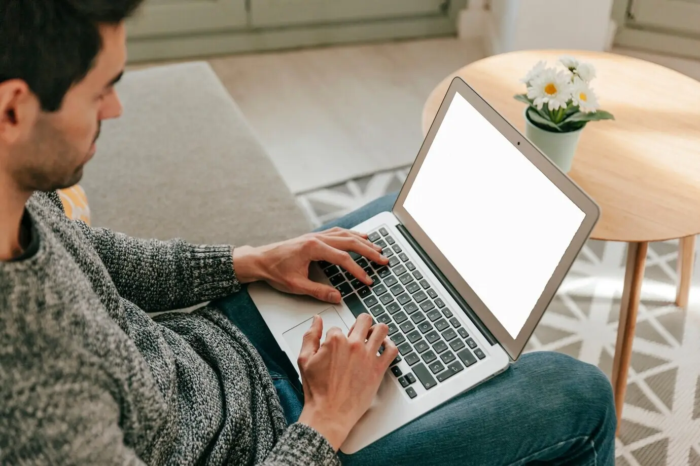Man on a sofa using a laptop
