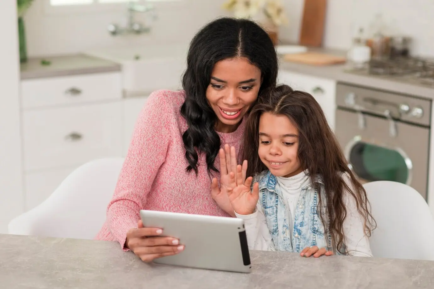 High-angle view of a mom and daughter using a tablet.